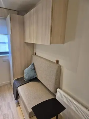 a small room with a bench with a pillow on it at For Student Only Student Roost Gibson Street in Glasgow