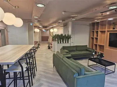 a living room with couches and a table and a bar at For Student Only Student Roost Gibson Street in Glasgow