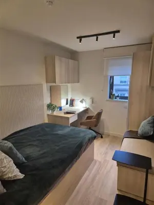 a bedroom with a bed and a desk in it at For Student Only Student Roost Gibson Street in Glasgow