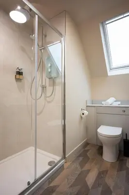 a bathroom with a shower and a toilet at Taynuilt Inn Apartments in Taynuilt