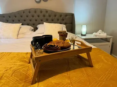a tray of food on a table on a bed at Peaceful Place in Falkirk