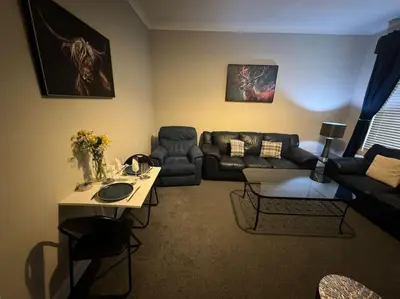 a living room with a couch and a table at Peaceful Place in Falkirk