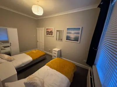a room with two beds and a window in it at Peaceful Place in Falkirk