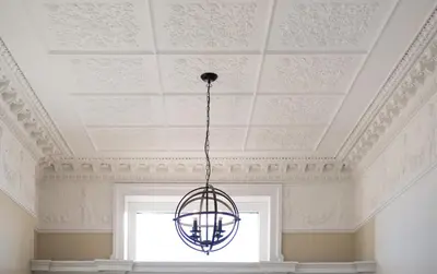 a chandelier hanging from a ceiling with a window at Extravagant 6 Bed Victorian Townhouse with Hot Tub in Glasgow