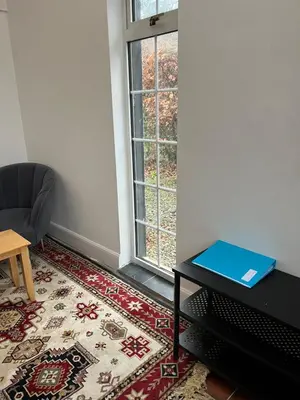 a room with a table and a chair and a window at Gogarstone Cottage in EDI