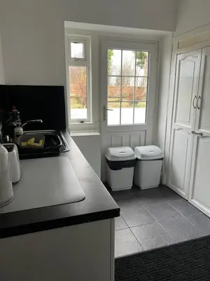 a kitchen with twowindows and a counter with two toilets at Gogarstone Cottage in EDI