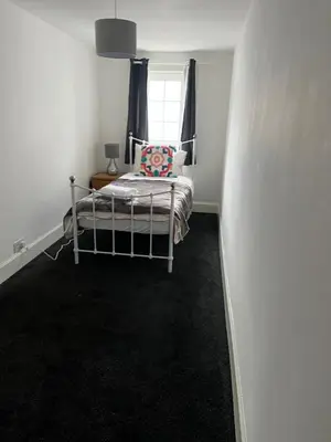 a small bedroom with a bed and a window at Gogarstone Cottage in EDI