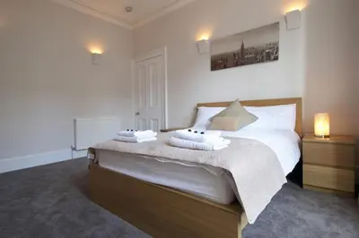 a bedroom with a bed with two towels on it at Modern City Centre Apartment in Central Hub in Edinburgh