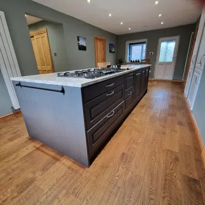 a large kitchen with a stove top island in a room at Sachsblick in Lochgoilhead