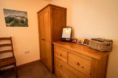 a wooden dresser with a laptop on top of it at Sachsblick in Lochgoilhead
