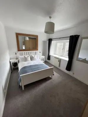 a bedroom with a bed and a large window at Bielding View Tarbert Loch Fyne Argyll in Tarbert