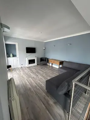 a living room with a couch and a tv at Bielding View Tarbert Loch Fyne Argyll in Tarbert