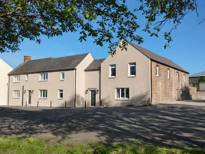 an old brick building with a large driveway at Family and dog friendly stunning barn conversion in Tarbolton
