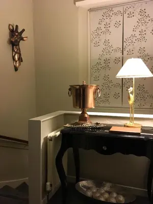 a table with a lamp and a trophy on it at Apartment 28 in Ayr