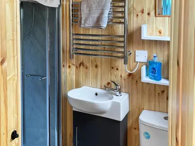 a bathroom with a sink and a shower and a toilet at Shepherds Cabin - Uk48225 in Ardgour