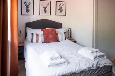 a bedroom with a bed with towels on it at Modern apartment with stunning sea views near Oban in Connel