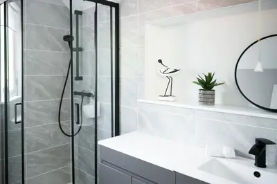 a bathroom with a shower and a sink at Modern apartment with stunning sea views near Oban in Connel