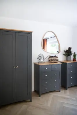 a bedroom with two dressers and a mirror at Modern apartment with stunning sea views near Oban in Connel