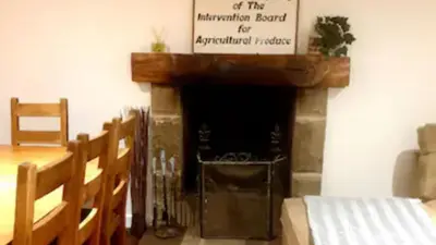 a church with a fireplace with a sign above it at Rowantree Cottage in Arrochar