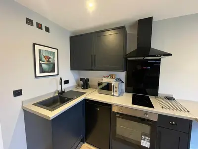 a small kitchen with a sink and a microwave at River Logie Lodges in Westfield