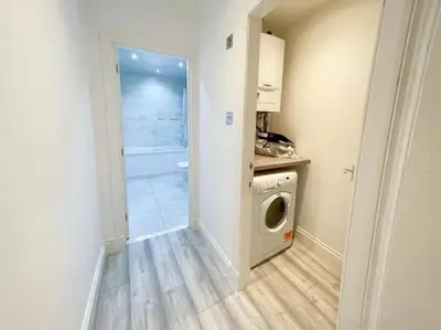 a laundry room with a washing machine and a washer at 2 Bed apartment in city centre! in Glasgow