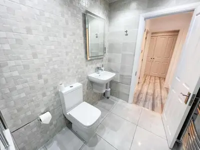 a bathroom with a white toilet and a sink at 2 Bed apartment in city centre! in Glasgow