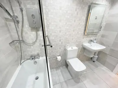 a bathroom with a shower and a toilet and a sink at 2 Bed apartment in city centre! in Glasgow