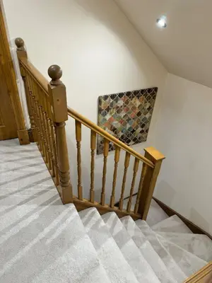 a staircase in a house with a rug on the wall at 2-Bed Cottage Sleeps 4 10 mins to Glasgow Centre in Glasgow