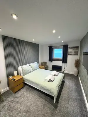 a bedroom with a large bed and a window at View of the Isles in Largs