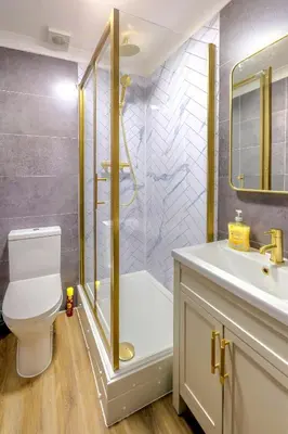 a bathroom with a shower and a toilet and a sink at Cosy 4 Bedroom Home In Glasgow City - Free Parking in Glasgow
