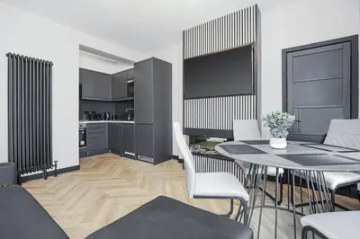 a kitchen and dining room with a table and chairs at 1 Bedroom Gorgie Sleeps 4 Easy City Access in Edinburgh