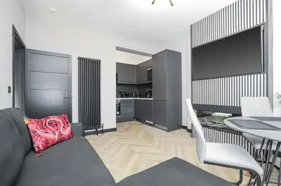 a living room with a couch and a table at 1 Bedroom Gorgie Sleeps 4 Easy City Access in Edinburgh