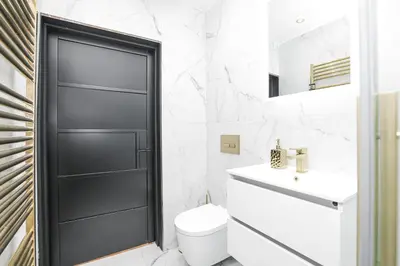 a bathroom with a toilet and a black door at 1 Bedroom Gorgie Sleeps 4 Easy City Access in Edinburgh