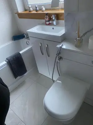 a bathroom with a white toilet and a sink at Comfy 3bed City centre apartment in Glasgow