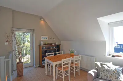 a dining room with a table and chairs at Black Barony Home Farm Cottage in Eddleston