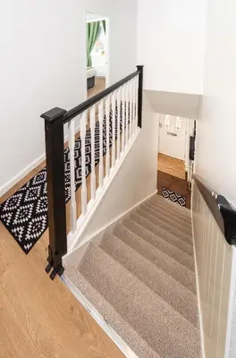 a staircase in a home with white walls at Tranquil Coastal Getaway Home in Saint Davids