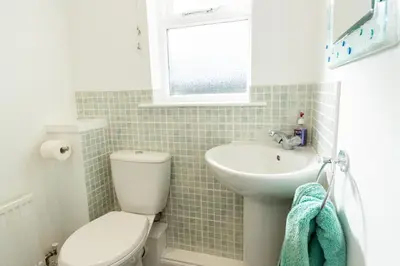 a bathroom with a toilet and a sink at Tranquil Coastal Getaway Home in Saint Davids