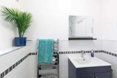 a bathroom with a sink and a mirror at Tranquil Coastal Getaway Home in Saint Davids