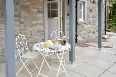 a table and two chairs with drinks and oranges on it at Am Tighndhuin in Killin