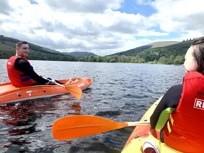 a man and a woman in kayaks on a lake at Am Tighndhuin in Killin