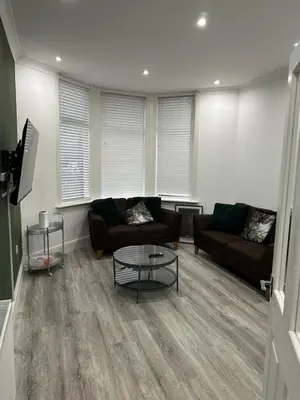 a living room with two couches and a coffee table at Cosy Flat in Glasgow