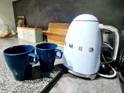 a coffee maker and two cups on a counter at Bright 3BR walking distance to town - FREE parking in Glasgow