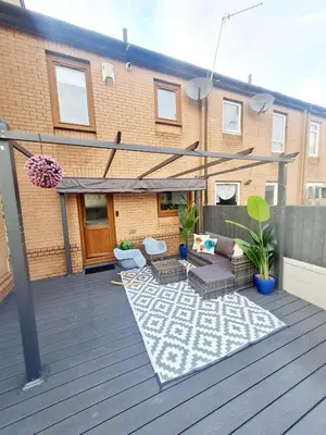 a patio with a couch and chairs on a deck at Bright 3BR walking distance to town - FREE parking in Glasgow