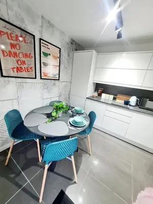 a kitchen with a table and chairs in a room at Bright 3BR walking distance to town - FREE parking in Glasgow