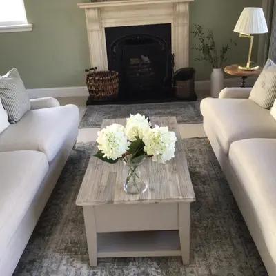 a living room with a vase of flowers on a coffee table at Castlecroft Bed and Breakfast in Stirling
