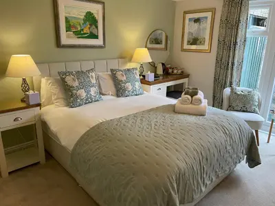 a bedroom with a large bed with a stuffed animal on it at Castlecroft Bed and Breakfast in Stirling