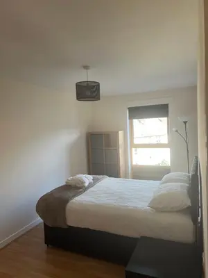 a white bedroom with a bed and a window at Riverview Retreat Shawlands in Mansewood