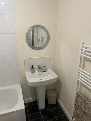 a white bathroom with a sink and a mirror at Riverview Retreat Shawlands in Mansewood