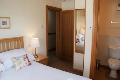a bedroom with a bed and a sink and a toilet at Greencourt Guest House in Oban