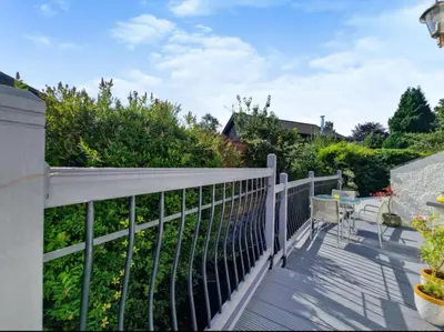 a balcony with a fence and a table and chairs at Clover Neuk - Hot Tub - Coorie Doon Stays in Fairlie